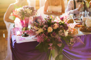white and purple flowers wedding accessories wedding preparation decorated wedding table with flowers wedding flowers wedding bouquet food on the table people sitting at the table